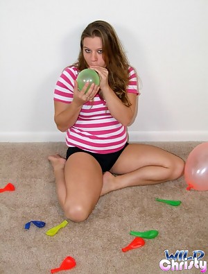 Winsome blonde teen beauty Christy playing with balloons on the floor