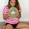 Winsome blonde teen peach Christy playing with balloons on the floor